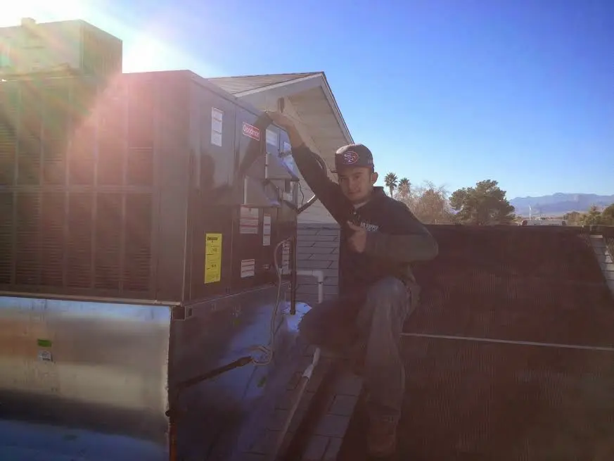 HVAC technician performing HVAC Inspection on a rooftop unit in Vergennes
